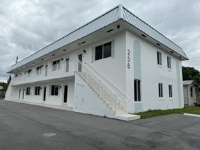 Delray Beach apartment for rent - A white building with the number 238 on it.