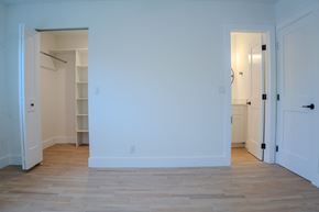 Delray Beach apartment for rent - A room with white walls and wooden flooring with two doors.