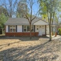 Montgomery house for rent - A small house with a red brick exterior and a white door.