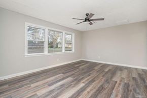 Montgomery house for rent - A room with a ceiling fan and wood flooring.