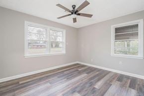 Montgomery house for rent - A room with a ceiling fan and two windows.