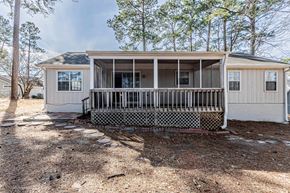 Midway Park house for rent - A house with a porch and a screened-in area.