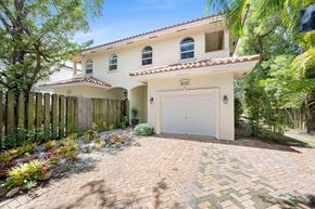 Miami townhouse for rent - A house with a white garage door and a brick driveway.