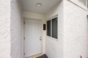 Miami apartment for rent - A white door with a window above it.