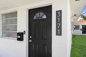 Miami triplex for rent - A black door with the number 3171 on the wall above it.