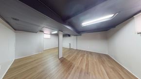 Cedar Lake house for rent - A room with wooden flooring and white walls.