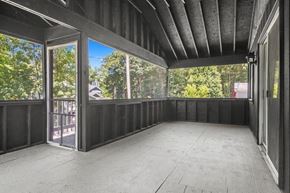 Cedar Lake house for rent - A balcony with a view of trees and houses.