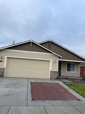 Hermiston house for rent - A house with a garage door and a driveway.