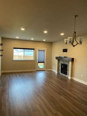 Hermiston house for rent - A room with a fireplace and a chandelier.