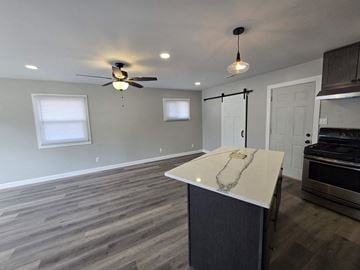 Gary house for rent - A kitchen with a white countertop and a ceiling fan.