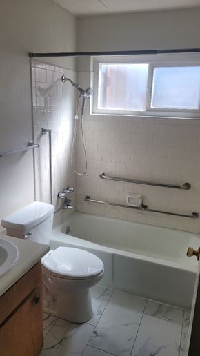 Stockton apartment for rent - A white toilet and sink in a bathroom.
