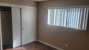 Stockton apartment for rent - A room with a white door and a window with blinds.