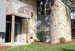 Madison apartment for rent - A building with a balcony and a tree in front of it.