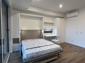 Kelowna house for rent - A bedroom with a bed, desk, and chair.