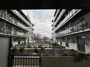 Kelowna house for rent - A view of a courtyard between two apartment buildings.