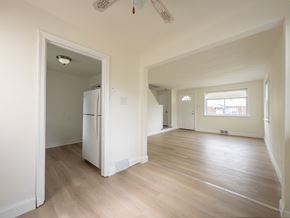 Paulsboro apartment for rent - A kitchen with a refrigerator and a doorway leading to another room.