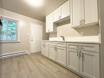 Charlotte apartment for rent - A kitchen with white cabinets and a window.
