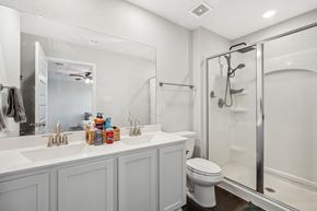 Von Ormy house for rent - A white bathroom with a toilet, sink, and shower.