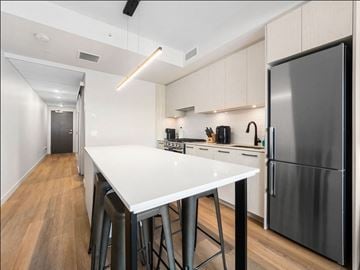 Calgary apartment for rent - A modern kitchen with a white countertop and stainless steel appliances.