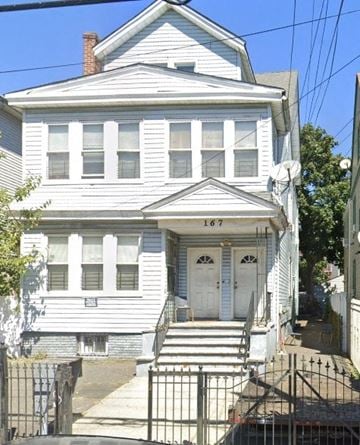 Newark apartment for rent - A white house with a black gate in front.