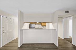 Hewitt apartment for rent - A white bedroom with a bed in the middle and a window above it.