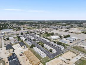 Hewitt apartment for rent - A large industrial area with multiple buildings and a parking lot.