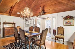 Gulf Shores house for rent - A dining room with a wooden table and chairs.