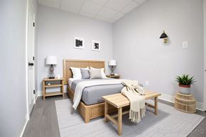 Philadelphia apartment for rent - A bedroom with a bed, nightstands, and a bench.