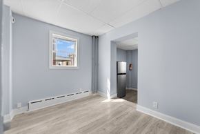Philadelphia apartment for rent - A room with a window, a fridge, and a door.