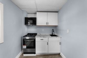 Philadelphia apartment for rent - A kitchen with a stove, oven, and cabinets.