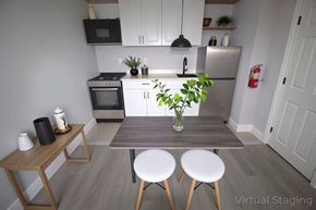 Philadelphia apartment for rent - A kitchen with a table and chairs in the foreground and a refrigerator in the background.