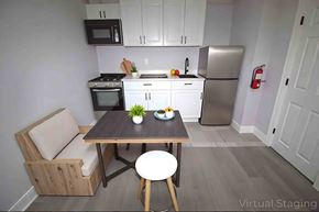Philadelphia apartment for rent - A kitchen with a table and chairs in the foreground and a refrigerator in the background.