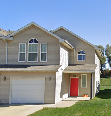 Newton apartment for rent - A house with a red door and a white garage door.