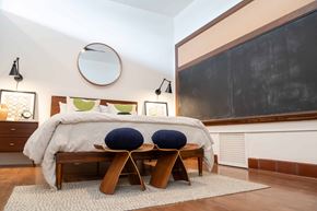 Cleveland apartment for rent - A bedroom with a large bed and two blue pillows.