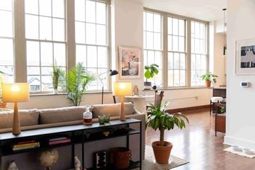 Cleveland apartment for rent - A living room with a couch, a table with candles, and a potted plant.