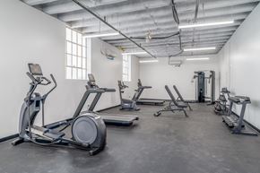 Cleveland apartment for rent - A gym with treadmills, elliptical machines, and weight machines.