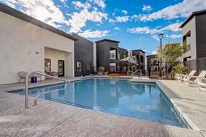 Glendale apartment for rent - A swimming pool in front of a building with a sunny sky.