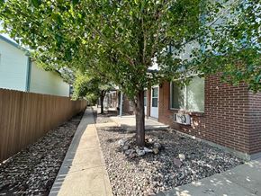 Lakewood apartment for rent - A small house with a brown door and a small porch.