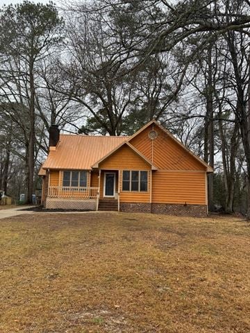 Jacksonville house for rent - A small wooden house with a brown roof and a porch.