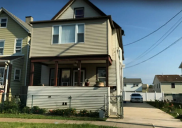 Carteret apartment for rent - A house with a grey siding and a white garage door.