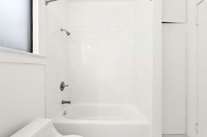 San Francisco house for rent - A white bathroom with a tub and toilet.