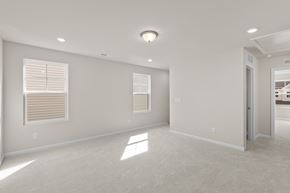 Durham house for rent - A spacious room with a carpeted floor and a window with blinds.