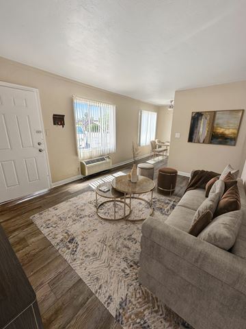 Las Vegas apartment for rent - A living room with a grey couch and a patterned rug.