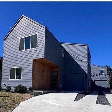 Austin house for rent - A modern house with a grey exterior and a wooden door.