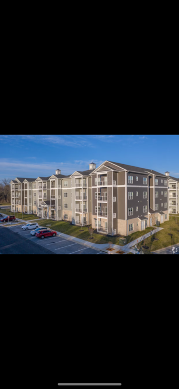 Winchester apartment for rent - A large apartment complex with multiple buildings and cars parked in the parking lot.