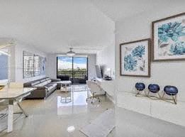 Aventura apartment for rent - A modern living room with a white couch and a large window.