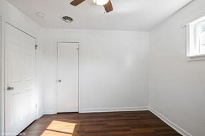 Gary house for rent - A room with a ceiling fan and two doors.