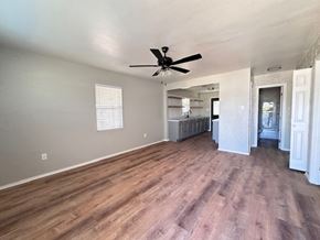 Snyder house for rent - A room with a ceiling fan and wooden flooring.