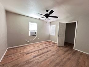Snyder house for rent - A room with a ceiling fan and a window with blinds.