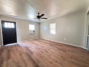 Snyder house for rent - A room with a ceiling fan and wooden flooring.